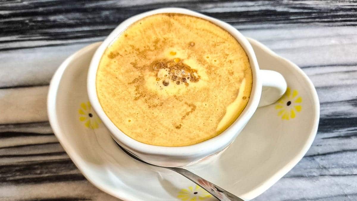 Close-up of egg coffee drink with yellow fluffy mixture