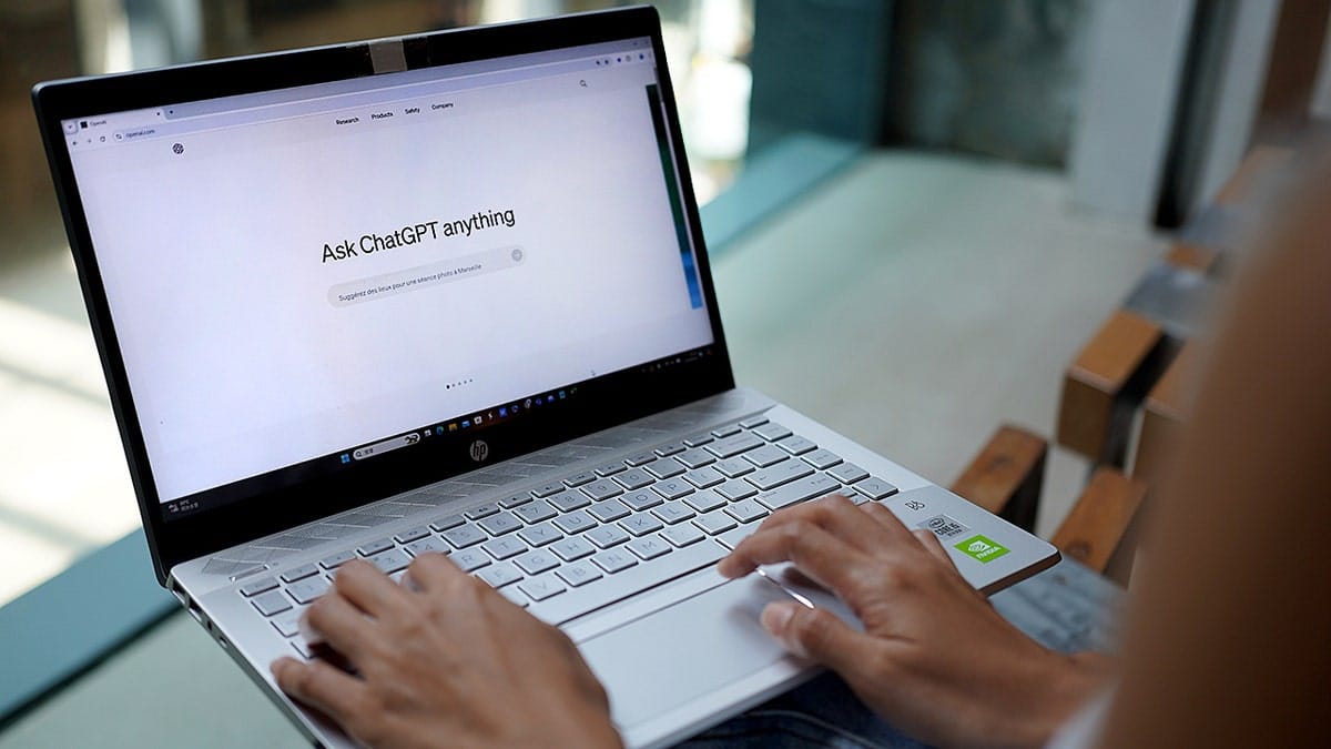 A person typing on a computer using ChatGPT.
