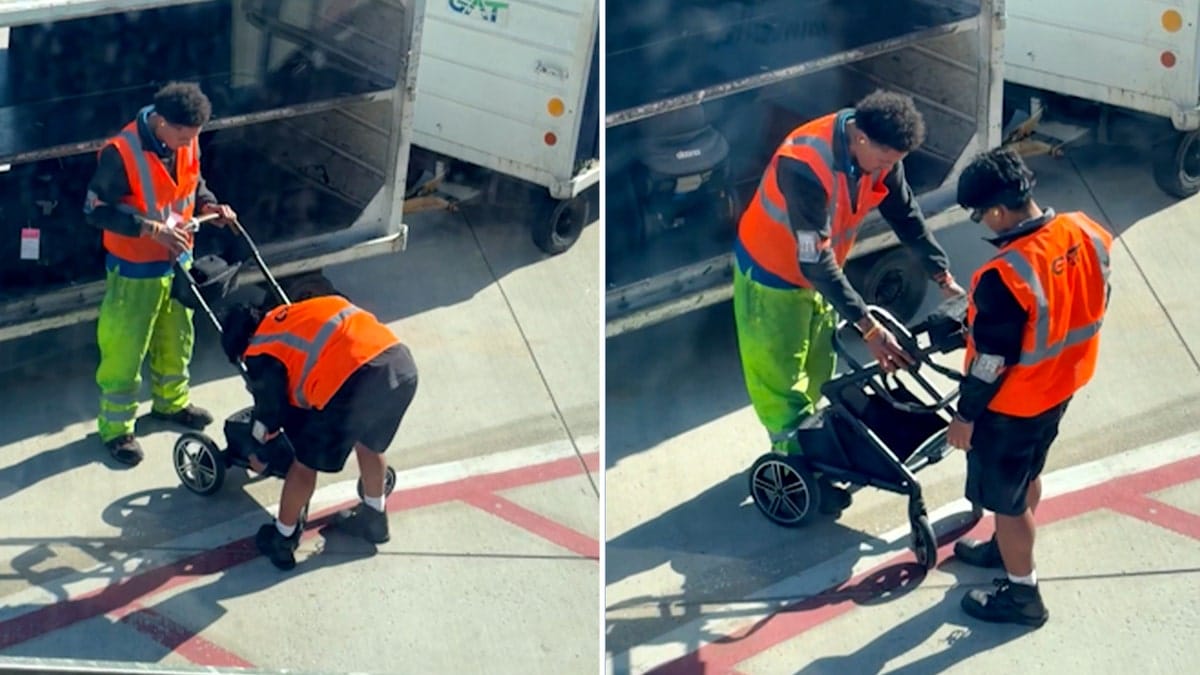 Airport workers in bright orange on the tarmac struggle to fold baby stroller.