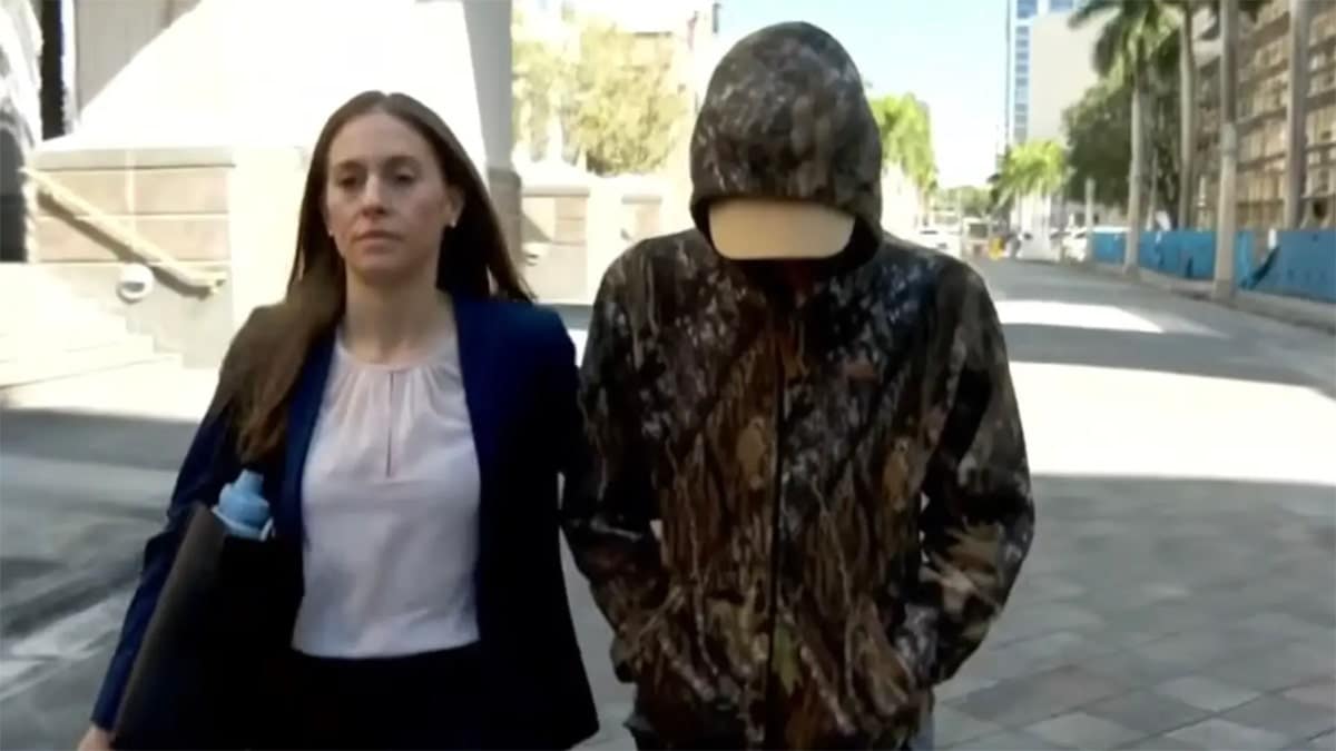 Anna Kepner's stepbrother in camouflage standing outside Miami federal court with lawyer