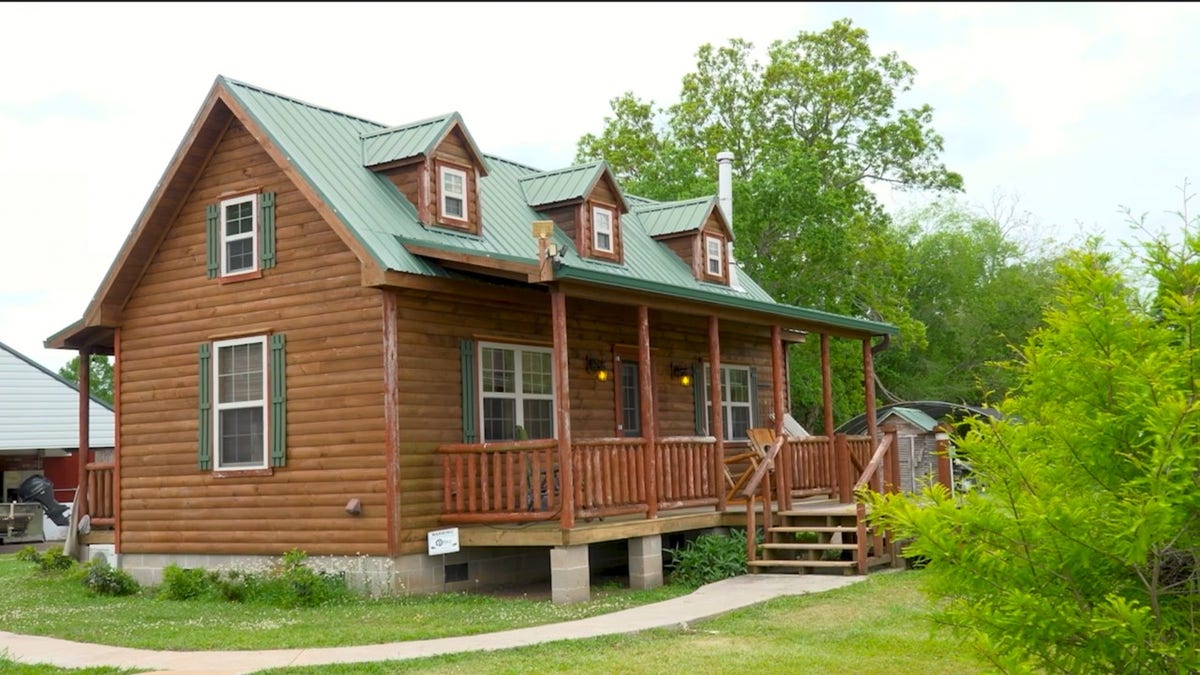 Wooden cabin house with green roof in Arnaudville Louisiana