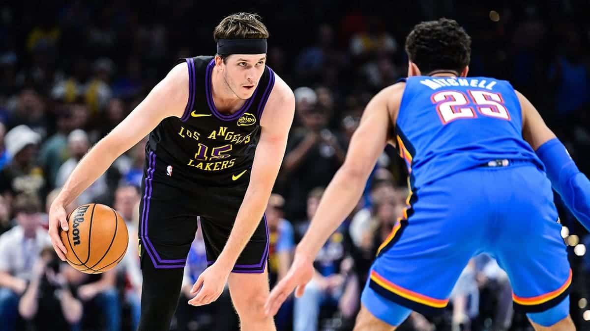 Los Angeles Lakers guard Austin Reaves drives against Oklahoma City Thunder guard Ajay Mitchell during a basketball game
