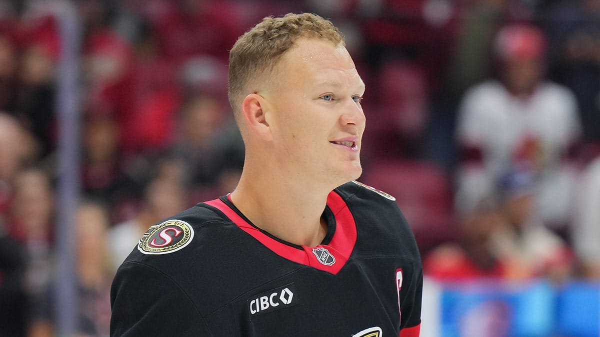 Brady Tkachuk of the Ottawa Senators looking on during warmup on ice.