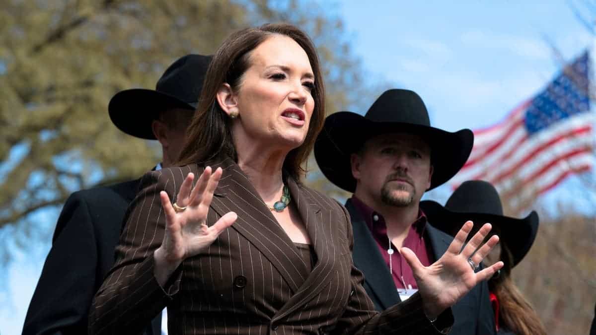 Agriculture Secretary Brooke Rollins speaks outdoors with American flag behind her