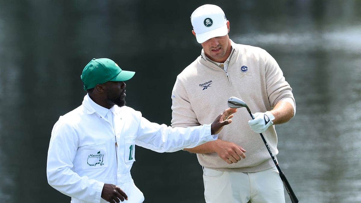Bryson DeChambeau reacts with caddie Kevin Hart at Augusta National Golf Club