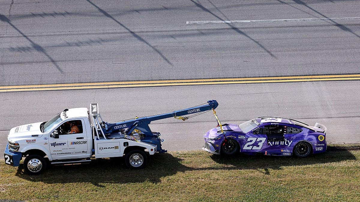 Bubba Wallace's #23 Xfinity Toyota being towed at Talladega Superspeedway