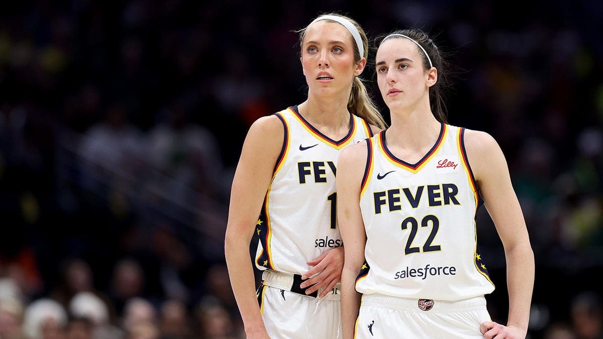 Lexie Hull and Caitlin Clark of the Indiana Fever watching the game at Climate Pledge Arena