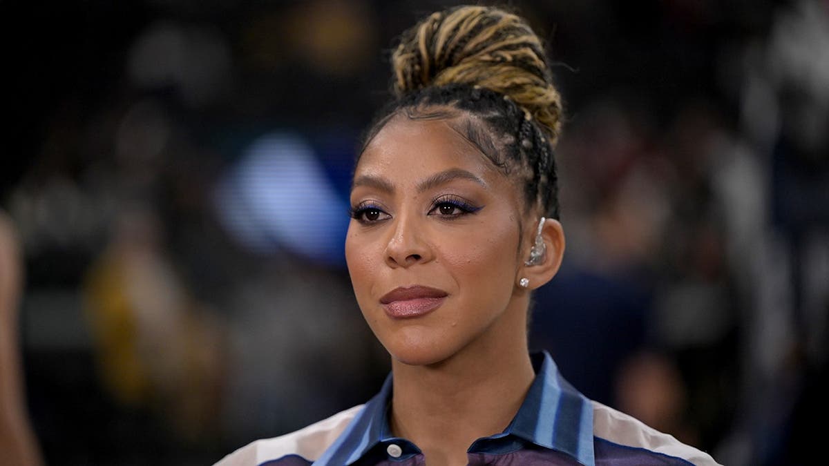 Candace Parker standing courtside at Intuit Dome during NBA game