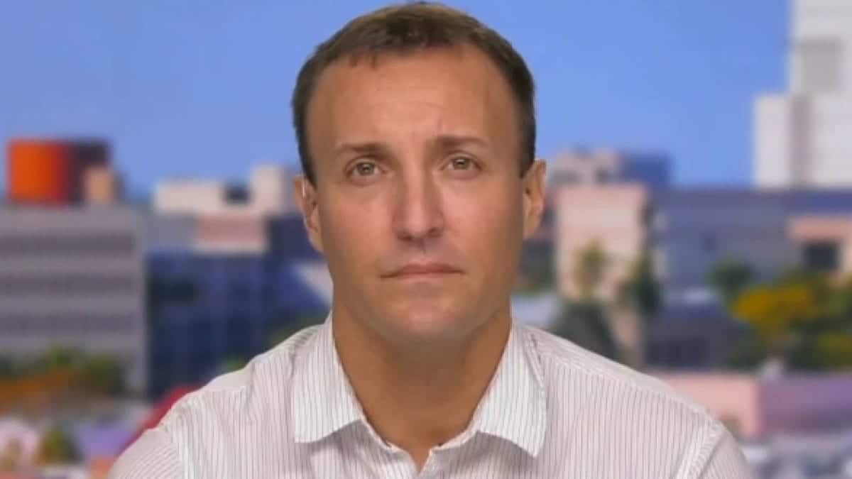 Stuart Scheller standing and speaking at a podium