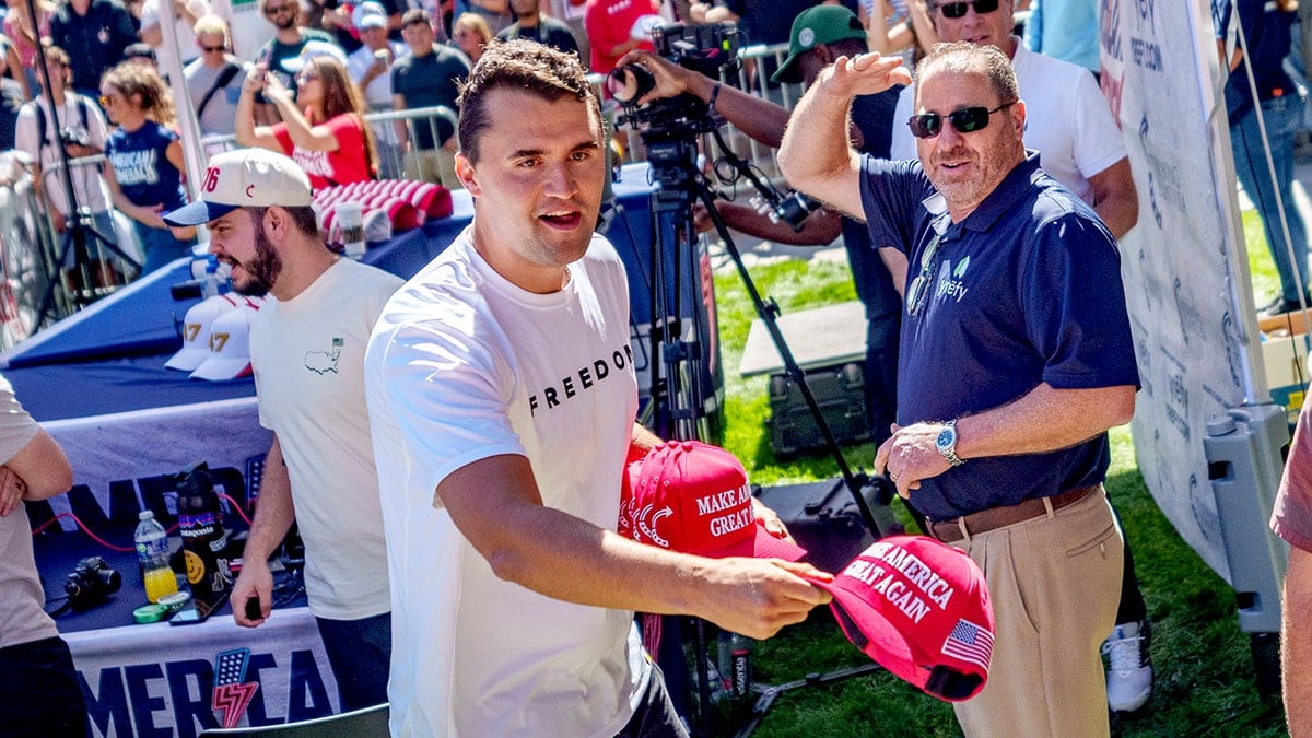 Charlie Kirk throws hats