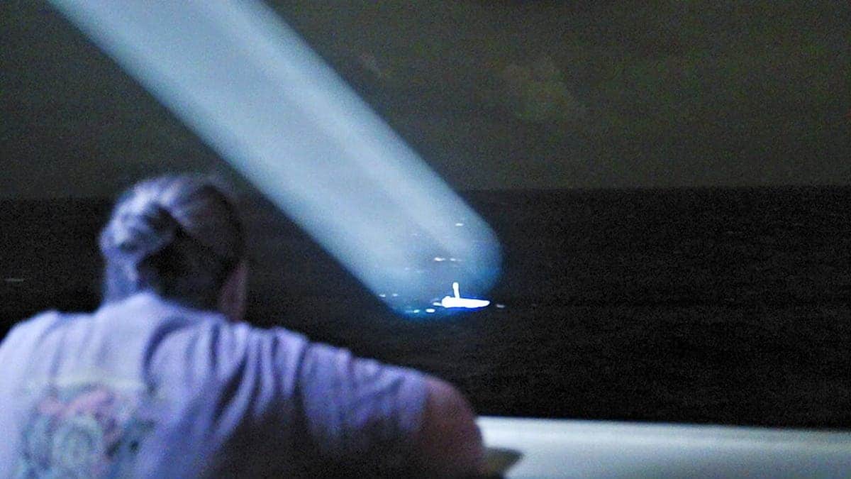 U.S. Coast Guard cutter crew locates small skiff at night during search and rescue mission near Chuuk State.