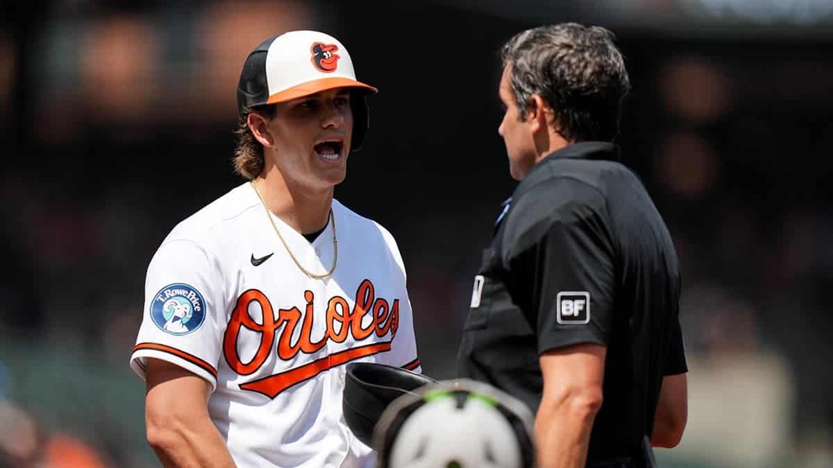 Baltimore Orioles' Coby Mayo talking with umpire John Tumpane on baseball field