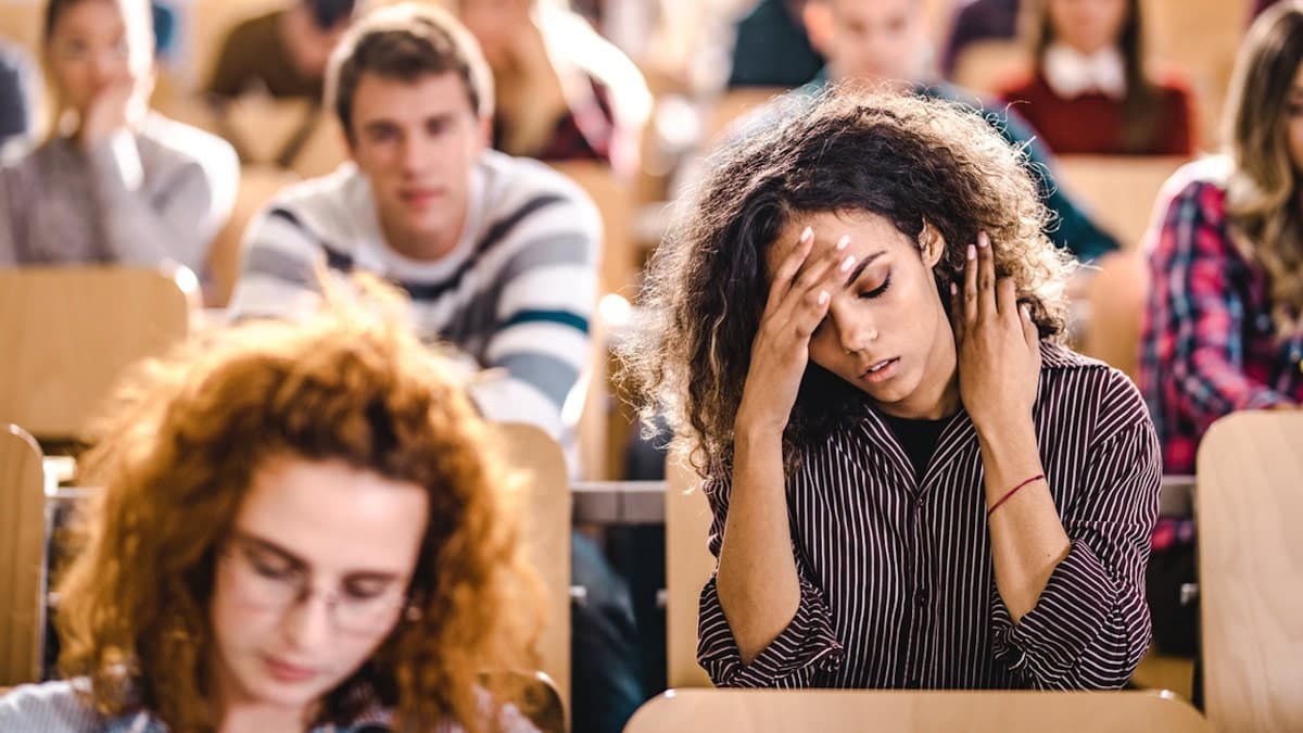 Female college student with her hand on her forehead