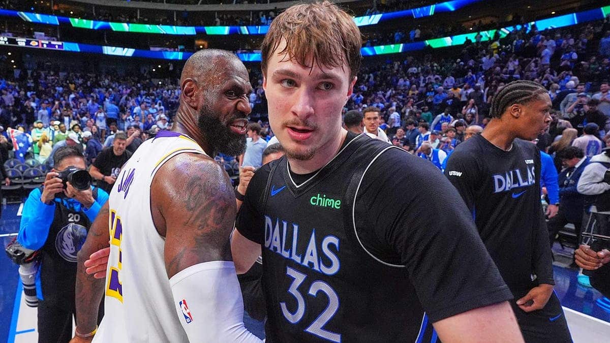 Dallas Mavericks forward Cooper Flagg hugging Los Angeles Lakers forward LeBron James on basketball court