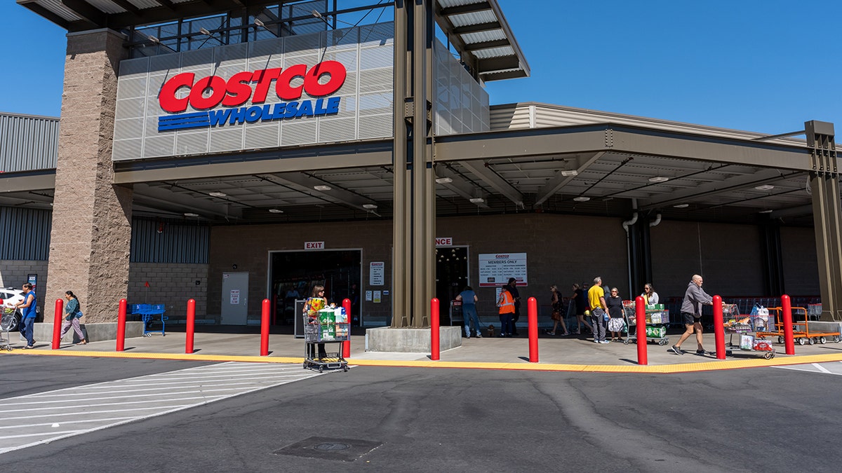 Customers leaving Costco store in Napa, California, carrying bulk purchases and pushing carts