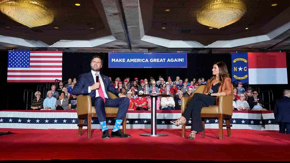 Sen. JD Vance speaking at a campaign event with Danica Patrick looking on in Greensboro
