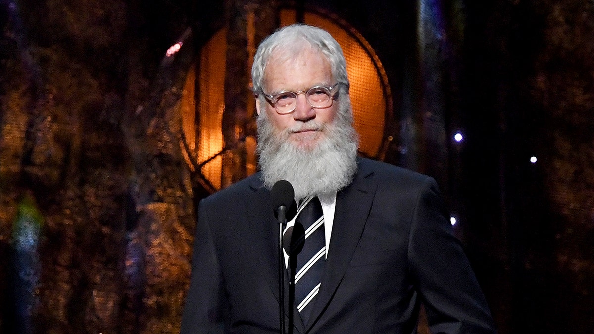 David Letterman speaking onstage at the Rock & Roll Hall of Fame Induction Ceremony