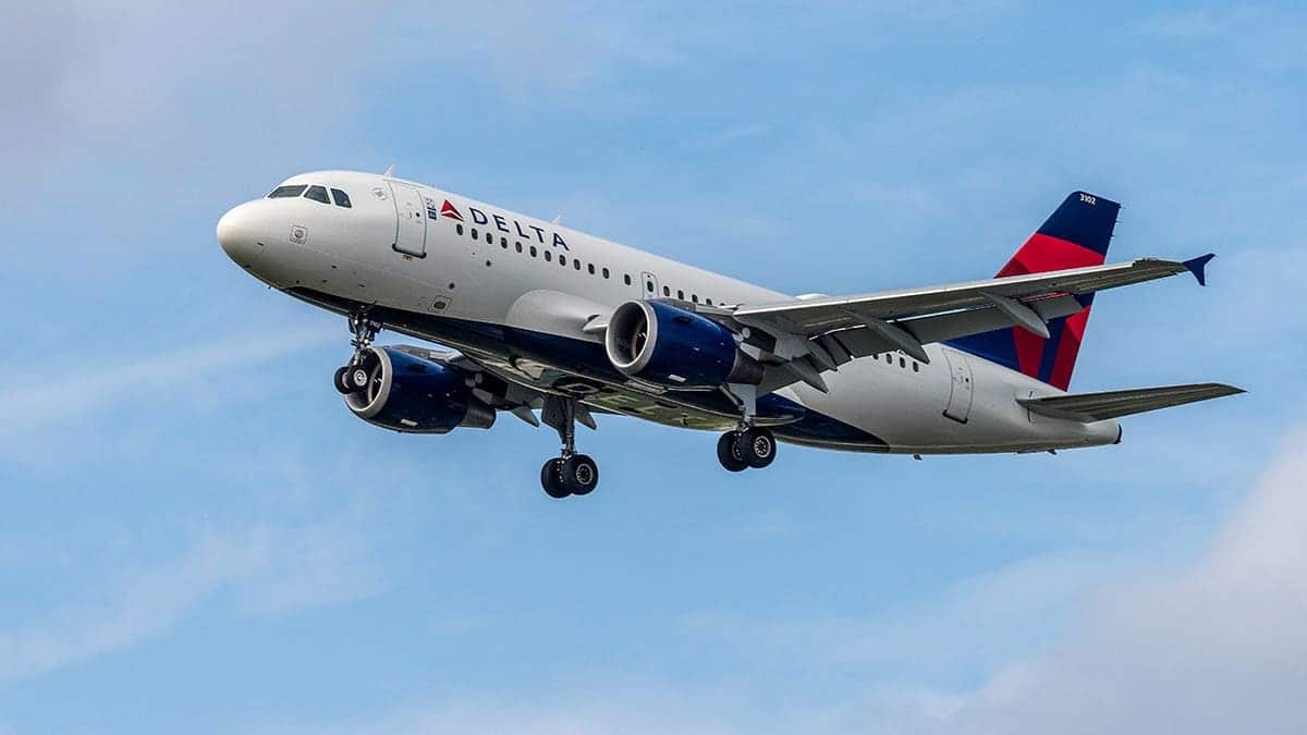 Delta Airlines airplane deploying landing gear while approaching Miami airport.
