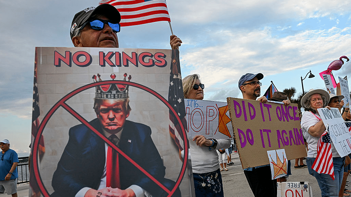 Protesters hold signs and flags