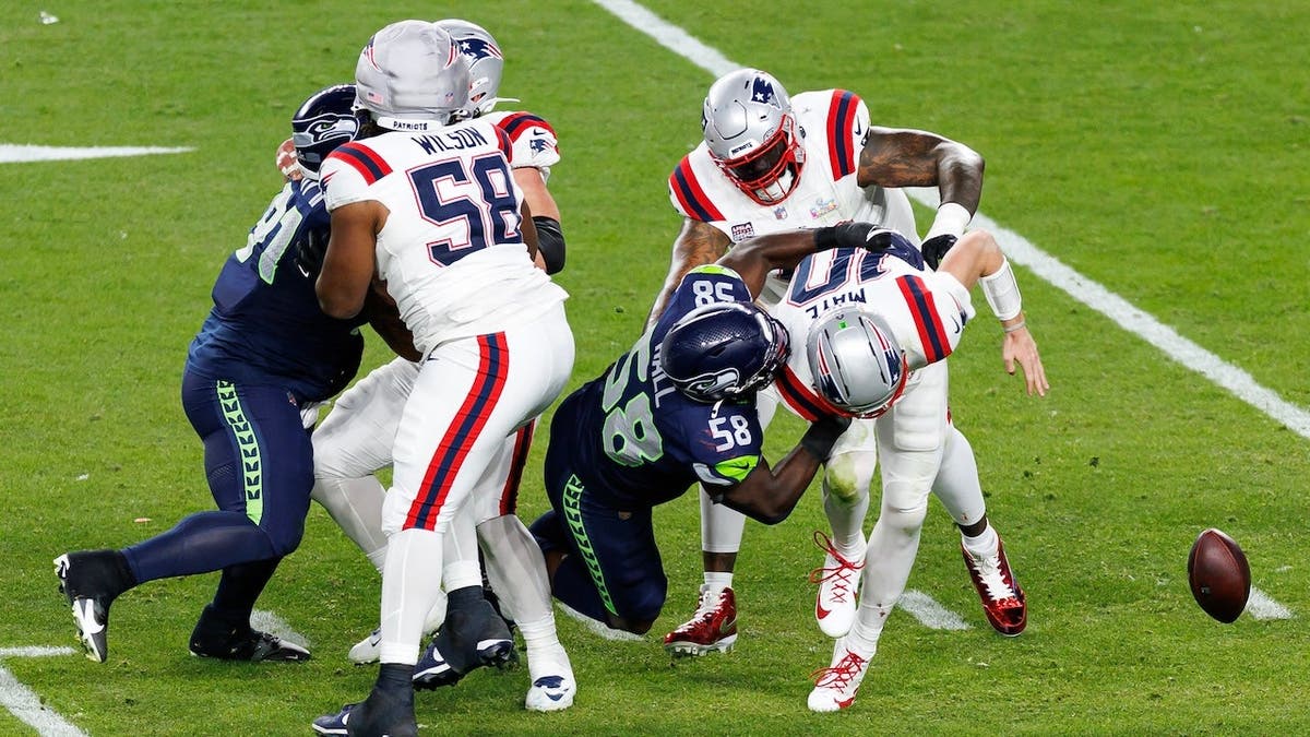 Derick Hall strip sacks Drake Maye during NFL Super Bowl at Levi's Stadium