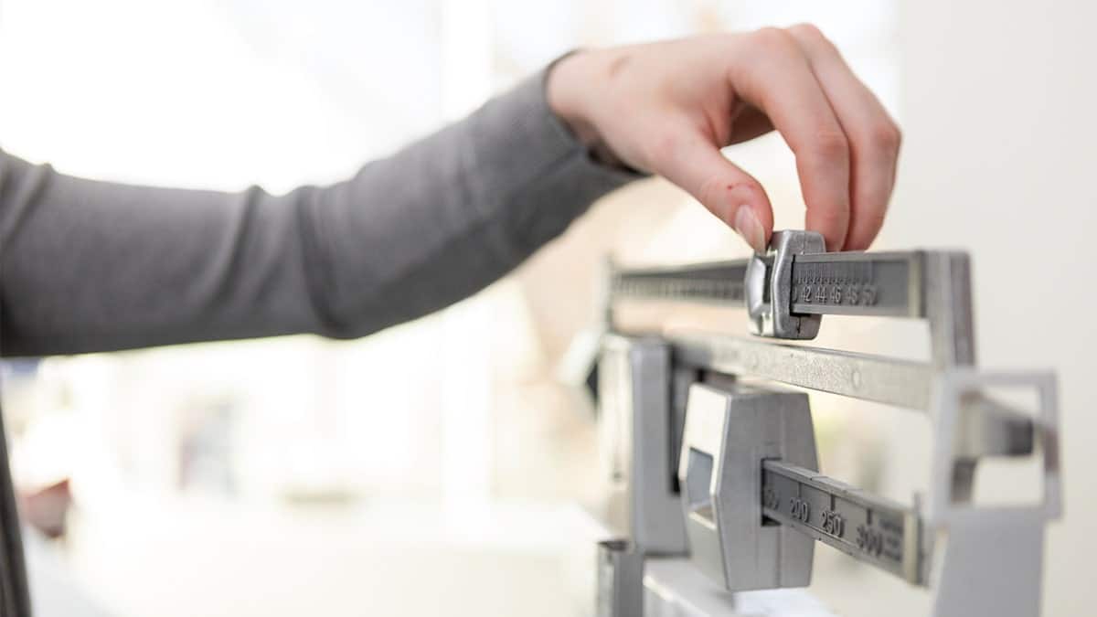 Woman weighing herself