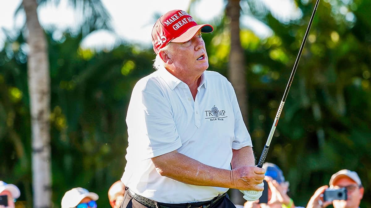 Former President Donald Trump watching his shot from the first tee at Trump National Doral Miami
