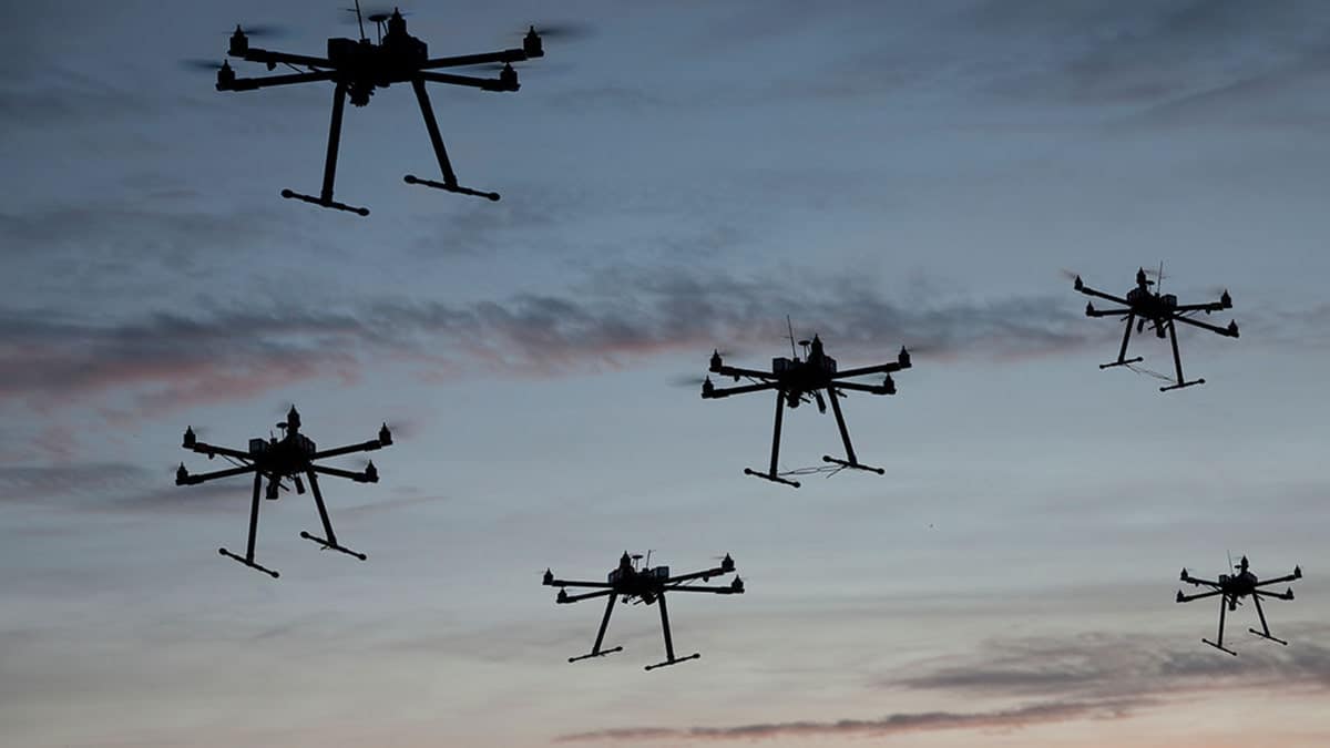 Swarm of drones flying in the sky