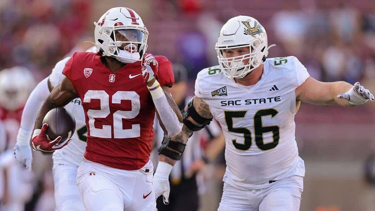 Stanford Cardinal running back E.J. Smith running with the ball past Sacramento State defensive lineman Brandon Knott at Stanford Stadium