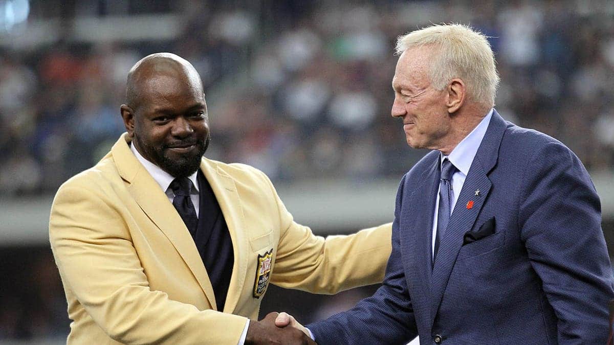 Emmitt Smith shaking hands with Jerry Jones at Cowboys Stadium
