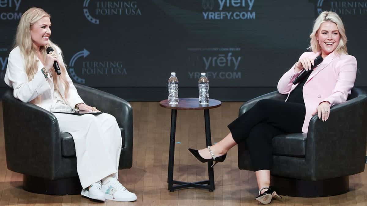 Erika Kirk speaking with Karoline Leavitt at a Turning Point USA event in Washington, D.C.
