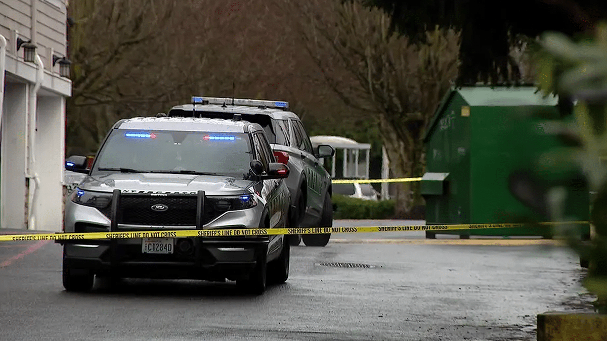 Police vehicles and crime scene tape block off a street in Everett, Washington during a stabbing investigation.