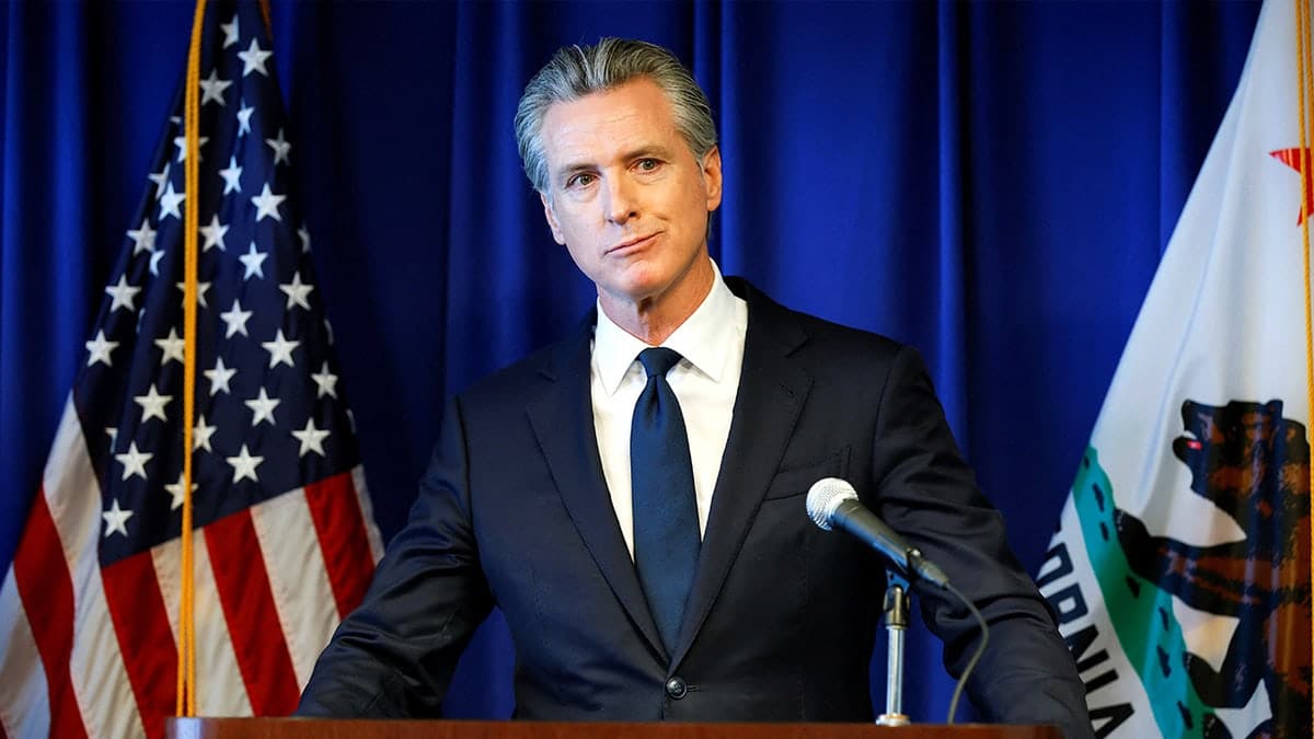 California Gov. Gavin Newsom speaking at a podium during a news conference