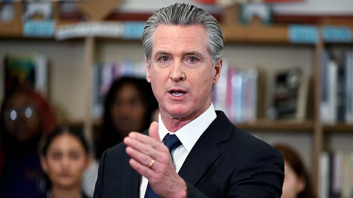 Governor Gavin Newsom speaking at a press conference at San Lorenzo High School