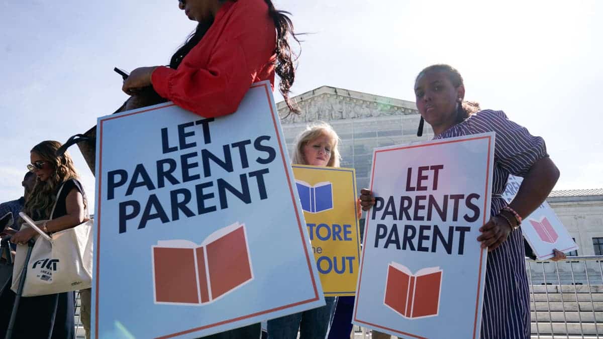 People holding signs protesting LGBTQ-related school content outside the US Supreme Court in Washington, D.C.