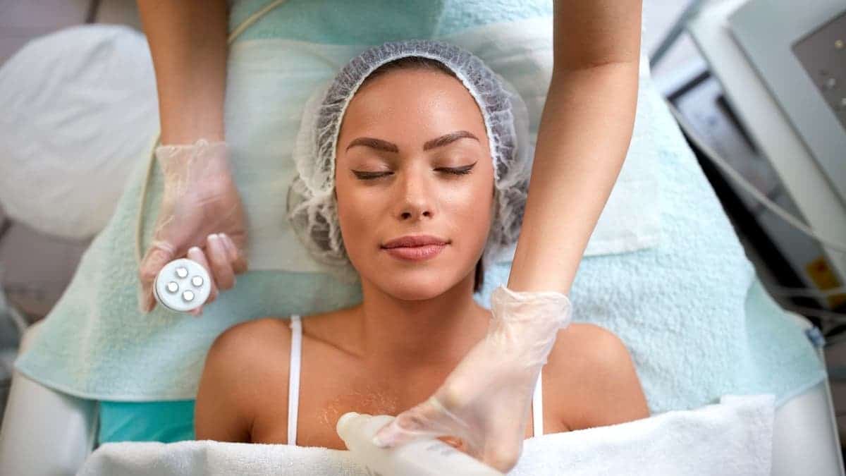 Girl receiving laser skin rejuvenation treatment in a clinical setting