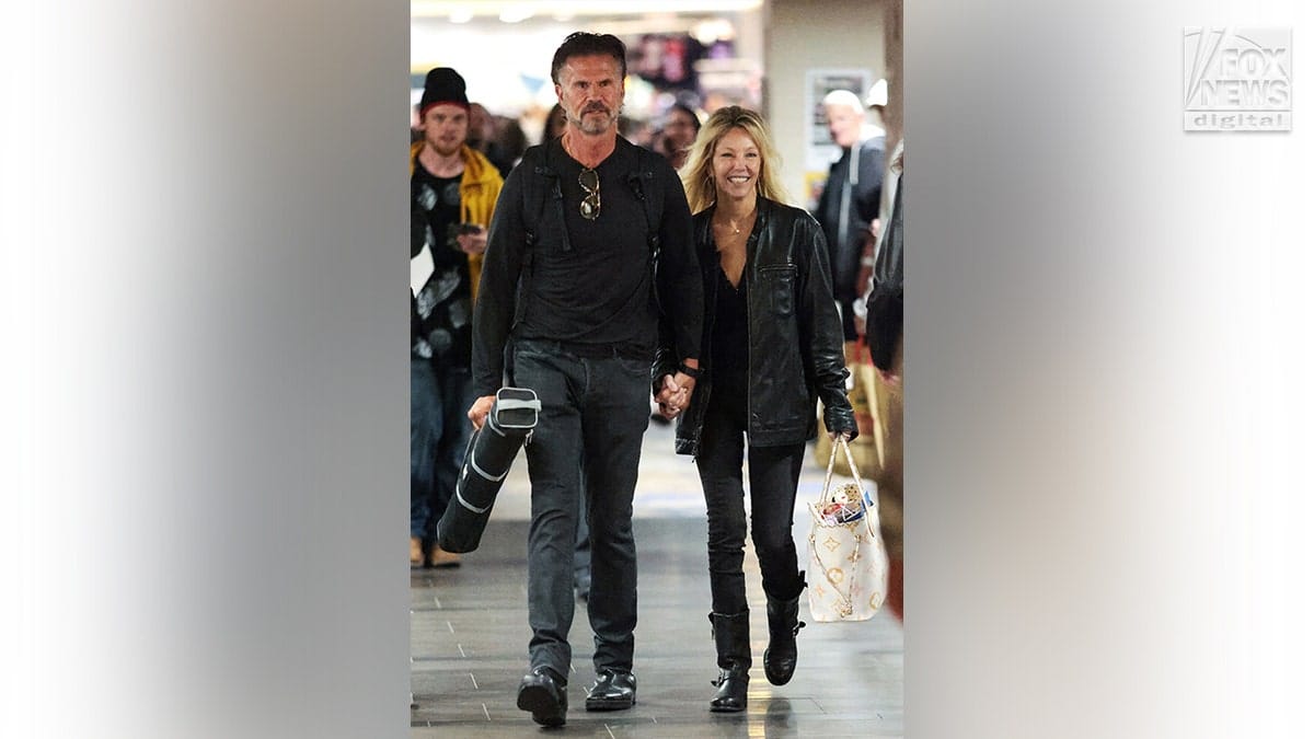 Lorenzo Lamas and Heather Locklear holding hands while leaving Chiller Theatre Expo.