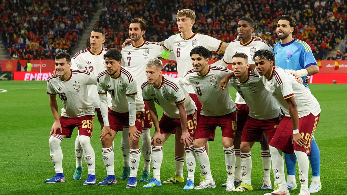 Spain players lined up on the field before a football match at RCDE Stadium