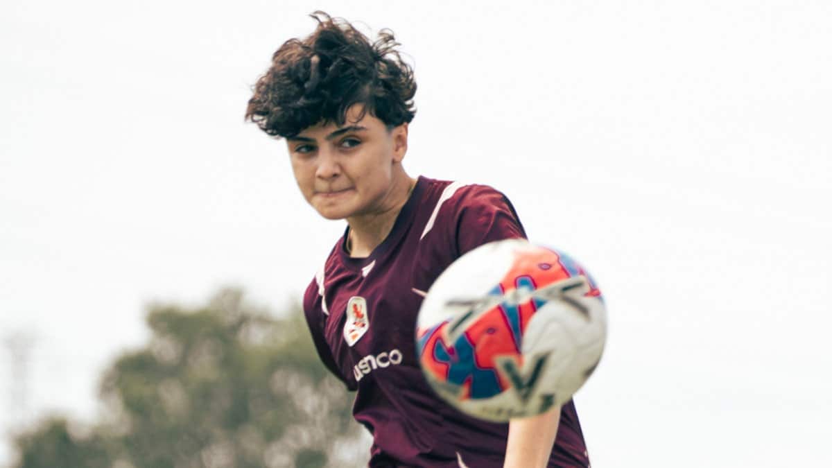 Iranian soccer player Fatemeh Pasandideh kicking a ball during Brisbane Roar training session