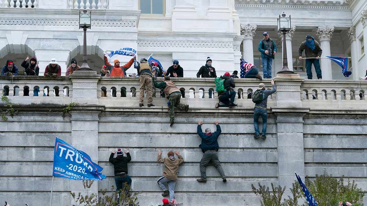 people climb capitol wall