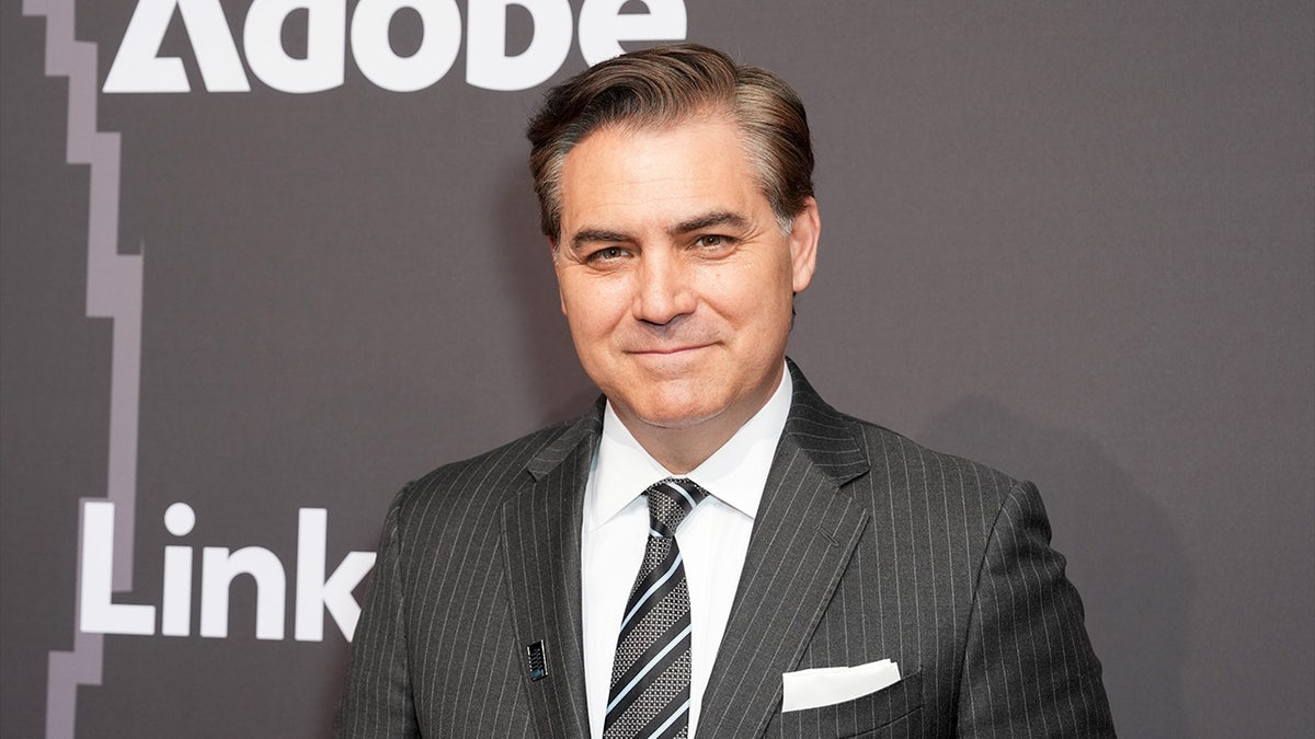 Jim Acosta standing and speaking during an interview.