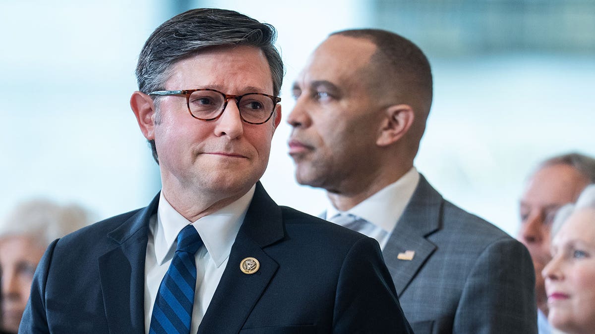 Mike Johnson and Hakeem Jeffries sitting together during a ceremony in Emancipation Hall.
