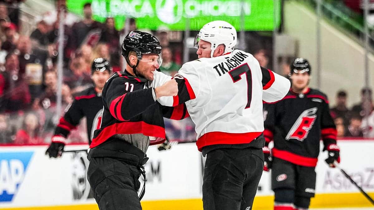 Jordan Staal and Brady Tkachuk fighting during a hockey game at Lenovo Center