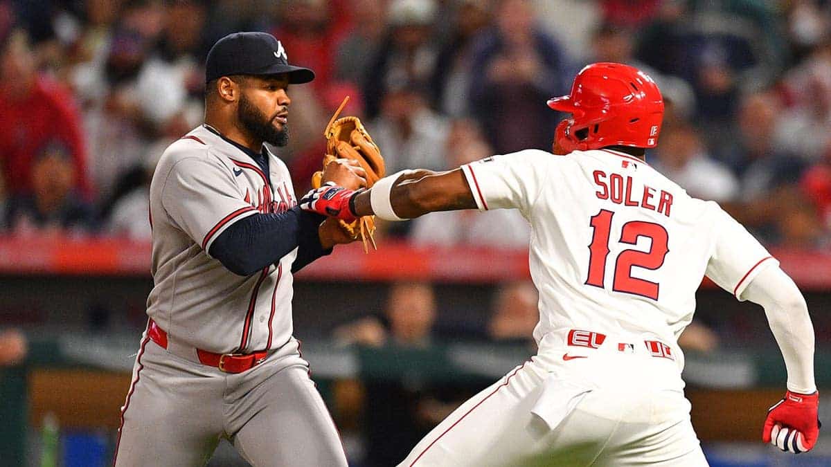 Los Angeles Angels designated hitter Jorge Soler charges Atlanta Braves pitcher Reynaldo Lopez on the mound at Angel Stadium