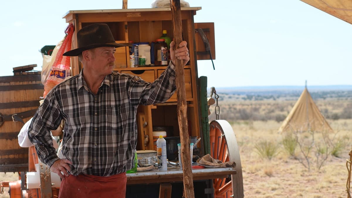 Kent Rollins standing outdoors with cooking equipment