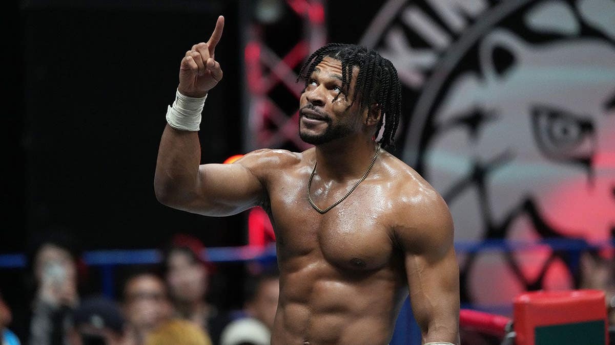 Kevin Knight celebrating victory in wrestling ring