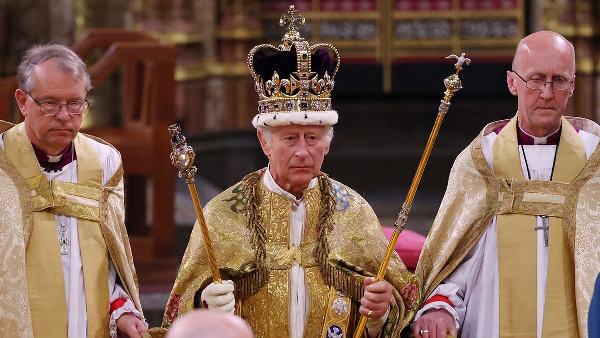 King Charles standing in ceremonial attire during his coronation.