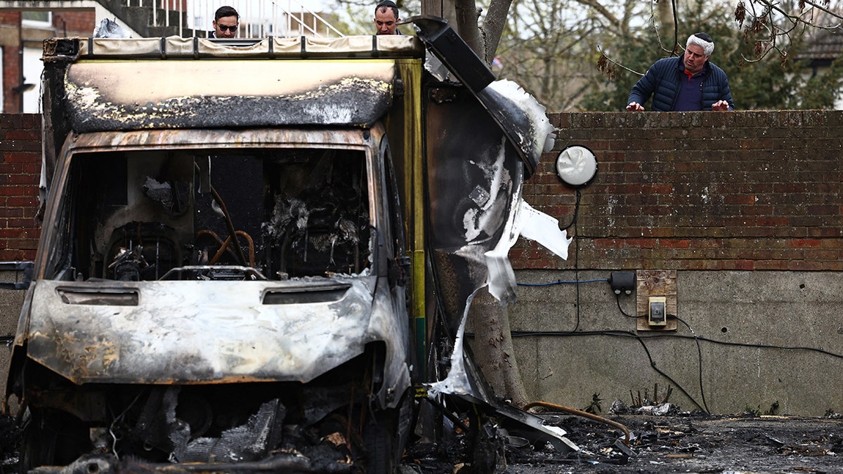 Members of the Jewish community viewing the scene of an arson attack in Golders Green north London