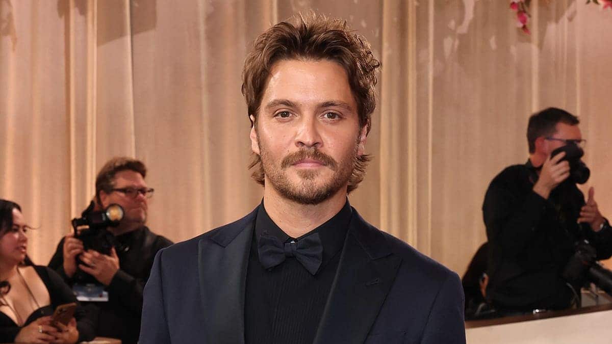 Luke Grimes standing in a suit at the Golden Globe Awards in Beverly Hills