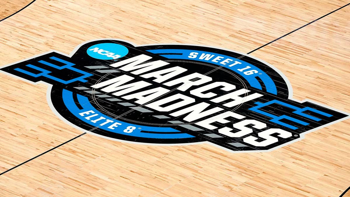 March Madness Sweet 16 Elite Eight logo on basketball court floor at Chase Center