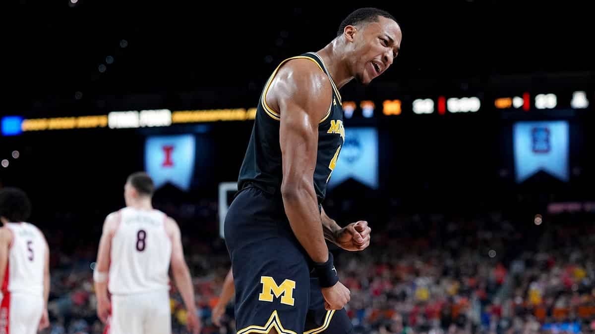Michigan guard Nimari Burnett celebrates a basket during a basketball game against Arizona.